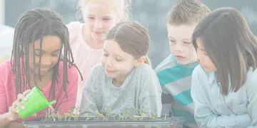 Pre-K students watering a plant