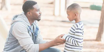 Dad talking to son as he leaves for work
