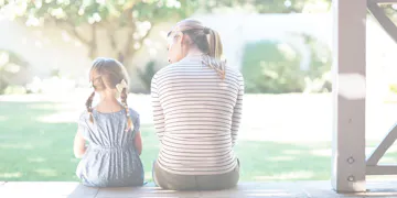 Mom and daughter sitting on porch