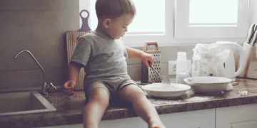 Toddler sitting on kitchen table