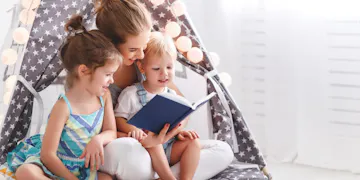Mom reading to little girl and boy