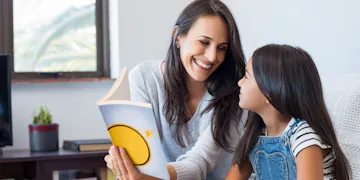 Mom reading to pre-kindergarten child