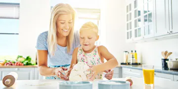 Mom cooking with little girl