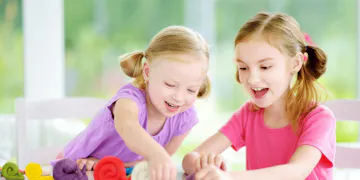 Little girls making playdough
