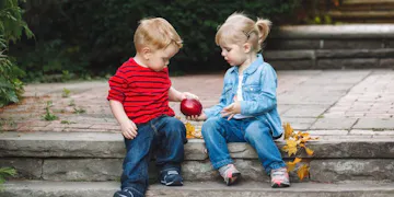 Two children practicing an important pillar of early childhood development: learning kindness and empathy.