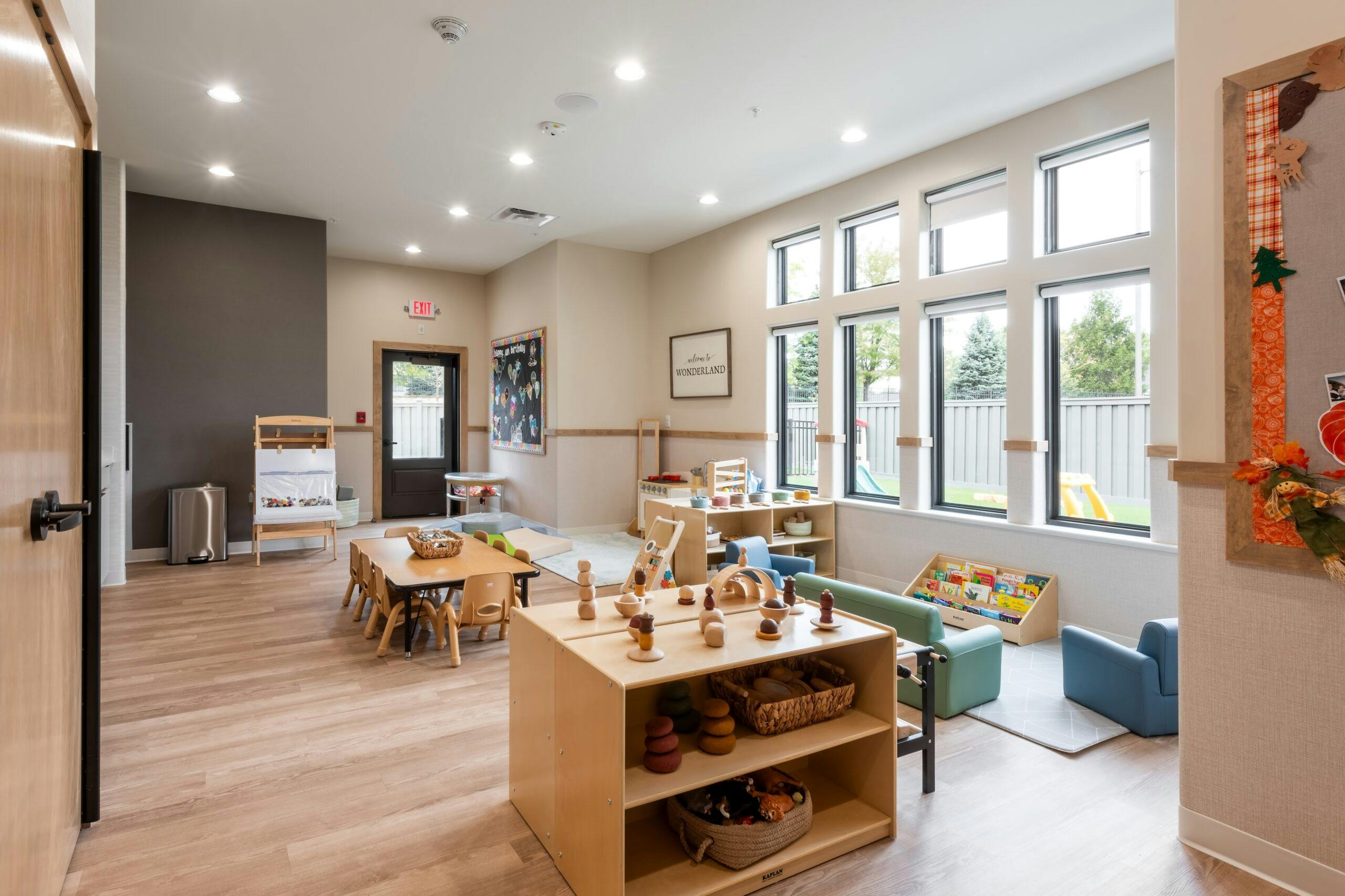 This Little Sunshine's Playhouse classroom sets an example for a neutral, clean, and well-lit space for children, following the Reggio Emilia approach.
