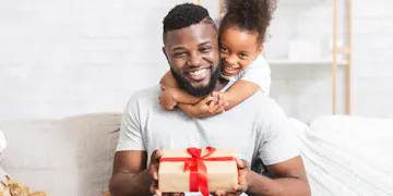 This father is teaching is daughter an important part of early childhood development: learning how to give.