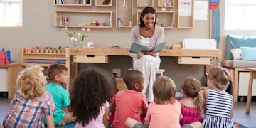 Teacher interacting with preschool program students using the foundation of Reggio Emilia Philosophy.