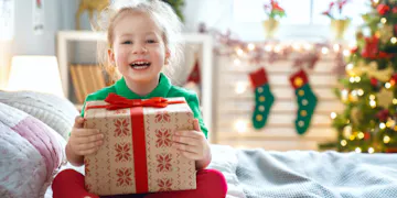 This young girl is enjoying the Christmas gift ideas her parents had for her.