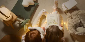 Children developing early literacy skills by reading the best books for preschoolers