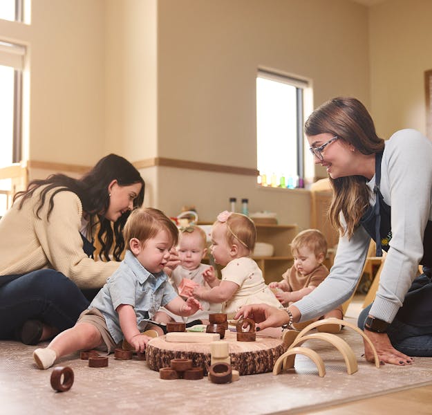 Babies socialize and play together in the classroom.