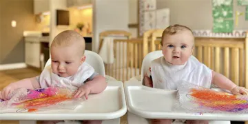 Two babies enjoying infant daycare at Little Sunshine's Playhouse!