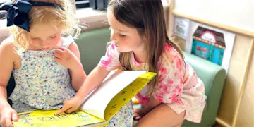 These little girls are on their journey toward early literacy!