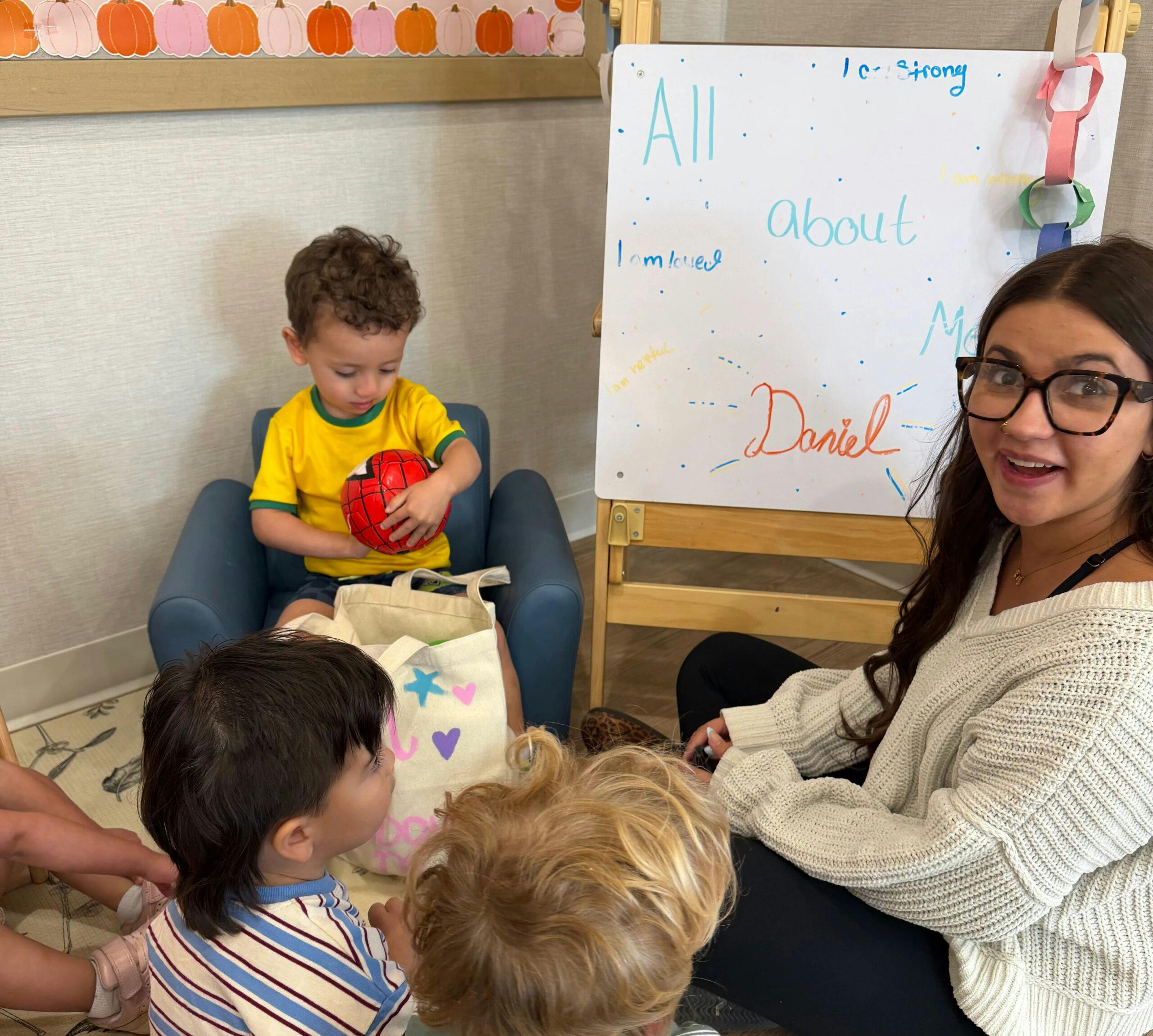 In this photo, one of our Little Sunshine's daycare educators is guiding a classroom show and tell!